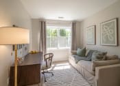 Thumbnail 7 of 33 - a office with a couch and a desk at Edgebrook Residences, Merrimack