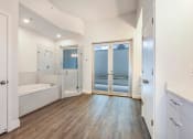 Thumbnail 17 of 36 - a master bathroom with a soaking tub and a walk in shower at Paramount on Lake Eola, Orlando, FL