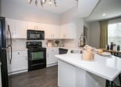 Thumbnail 14 of 40 - Kitchen with counter seating at Emblem Alpharetta, Alpharetta, 30009