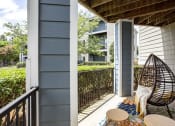 Thumbnail 7 of 14 - a balcony with two chairs and an egg chair at Thornberry Apartments, Charlotte, NC