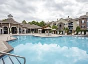 Thumbnail 9 of 14 - a large swimming pool with apartment buildings in the background at Thornberry Apartments, Charlotte North Carolina