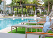 Thumbnail 21 of 41 - A poolside lounge area l at Floresta apartments in Jupiter, FL