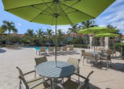 Thumbnail 12 of 21 - Poolside tables and umbrellas at Monterra at Bonita Springs, Bonita Springs, Florida