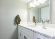 Thumbnail 36 of 37 - A white bathroom with a sink and mirror.