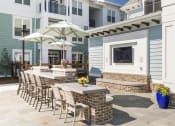 Thumbnail 2 of 37 - Poolside TV Lounge & Grilling Station at Wharf 7 Apartments, Charleston, 29492