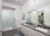 Thumbnail 7 of 12 - a bathroom with a large mirror and two sinks at SLX Atlanta, Georgia, 30341