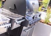 Thumbnail 37 of 40 - an outdoor grill with the door open and a grill grate on it at Maven on Broadway, Rochester, MN