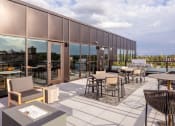 Thumbnail 30 of 40 - a patio with tables and chairs on the roof of a building at Maven on Broadway, Minnesota