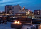 Thumbnail 9 of 40 - a rooftop fire pit with a city skyline in the background at Maven on Broadway, Minnesota, 55904