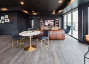 Thumbnail 22 of 40 - a lounge area with a table and chairs and a large window at Maven on Broadway, Minnesota, 55904