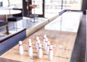 Thumbnail 38 of 40 - a row of bowling pins on a shuffleboard court at Maven on Broadway, Rochester, MN, 55904