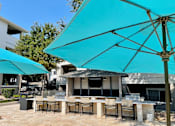 Thumbnail 28 of 30 - Outdoor lounge with gas grills at Stonelake at the Arboretum, Austin