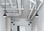 Thumbnail 40 of 40 - a conference room with white chairs and a table and ceiling lights at Maven on Broadway, Rochester, MN, 55904