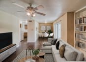 Thumbnail 11 of 31 - a living room with a couch and a coffee table in front of a tv at Village Oaks Apartments, Austin, Texas 