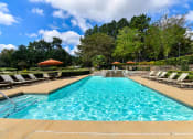Thumbnail 13 of 25 - a swimming pool with lounge chairs and umbrellas at 670 Thornton, Lithia Springs, 30122
