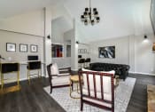 Thumbnail 6 of 25 - a living room with a black couch and white chairs at 670 Thornton, Lithia Springs, 30122