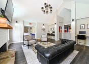 Thumbnail 4 of 25 - a living room with a black leather couch and two chairs at 670 Thornton, Georgia