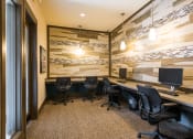 Thumbnail 14 of 36 - a conference room with desks and chairs and a wall of wood paneling at Estate at Woodmen Ridge, Colorado Springs