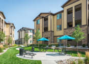 Thumbnail 23 of 36 - our apartments have a patio with umbrellas and tables at Estate at Woodmen Ridge, Colorado Springs, CO