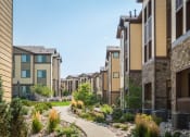 Thumbnail 32 of 36 - a row of townhouses with a sidewalk in front of them at Estate at Woodmen Ridge, Colorado Springs Colorado
