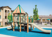 Thumbnail 26 of 36 - a childrens playground with slides in front of a house at Estate at Woodmen Ridge, Colorado Springs