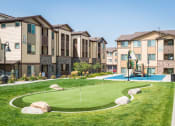Thumbnail 25 of 36 - an outdoor basketball court in front of a row of houses at Estate at Woodmen Ridge, Colorado Springs Colorado