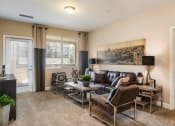 Thumbnail 2 of 36 - a living room with a couch and chairs and a table at Estate at Woodmen Ridge, Colorado