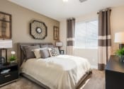 Thumbnail 4 of 36 - an empty bedroom with a bed and a windowat Estate at Woodmen Ridge, Colorado Springs, 80923