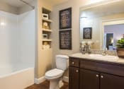 Thumbnail 6 of 36 - a bathroom with a toilet sink and shower and a mirrorat Estate at Woodmen Ridge, Colorado Springs, CO 80923