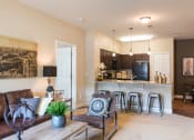 Thumbnail 3 of 36 - a living room with a couch and a kitchen with a bar at Estate at Woodmen Ridge, Colorado Springs, 80923