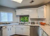 Thumbnail 1 of 29 - Kitchen with white cabinets at Arterra, Albuquerque, NM, 87113