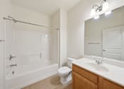 Thumbnail 17 of 50 - A white bathroom with a toilet, sink, and bathtub.