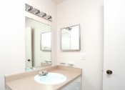 Thumbnail 10 of 12 - a white bathroom with a sink and a mirror