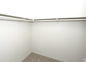 Thumbnail 8 of 12 - an empty closet in a white room with white walls and a window