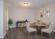 Thumbnail 16 of 20 - A dining room with a round table and chairs.