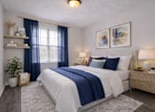Thumbnail 17 of 20 - A bedroom with a large bed, a window with blue curtains, and a painting on the wall.