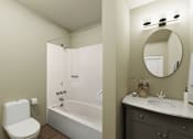 Thumbnail 8 of 14 - A white toilet sits next to a white bathtub in a bathroom.