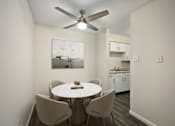Thumbnail 13 of 14 - A dining room with a white table and chairs.