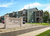 Thumbnail 1 of 16 - A large building with the name Wanamaker View Apartments on a stone pillar in front.