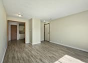 Thumbnail 13 of 16 - A room with a wooden floor and white walls.