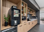Thumbnail 17 of 21 - a kitchen with wooden cabinets and a black coffee machine in it