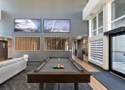 Thumbnail 12 of 21 - a living room with a pool table and a television
