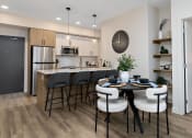 Thumbnail 4 of 21 - an open kitchen and dining room with a table and chairs