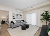 Thumbnail 5 of 21 - a living room with a couch and a coffee table    and a large