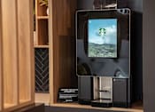Thumbnail 17 of 21 - A coffee machine with a digital display showing a green landscape.