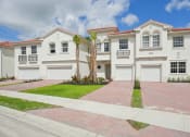 Thumbnail 1 of 48 - a white house with two palm trees in front of it