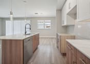Thumbnail 3 of 48 - a large kitchen with wooden cabinets and white counter tops