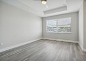 Thumbnail 37 of 48 - the living room of an apartment with wood floors and a large window