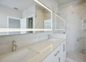 Thumbnail 30 of 48 - the ensuite bathroom has two sinks and a large mirror