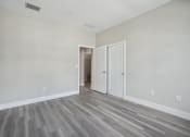 Thumbnail 40 of 48 - an empty living room with wood floors and white walls